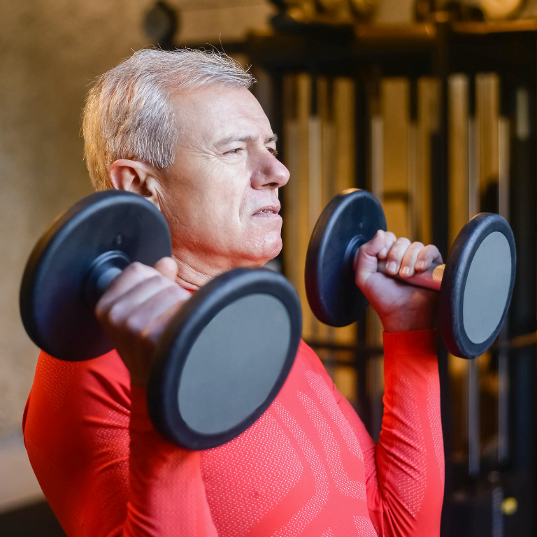 Older man lifting dumbells